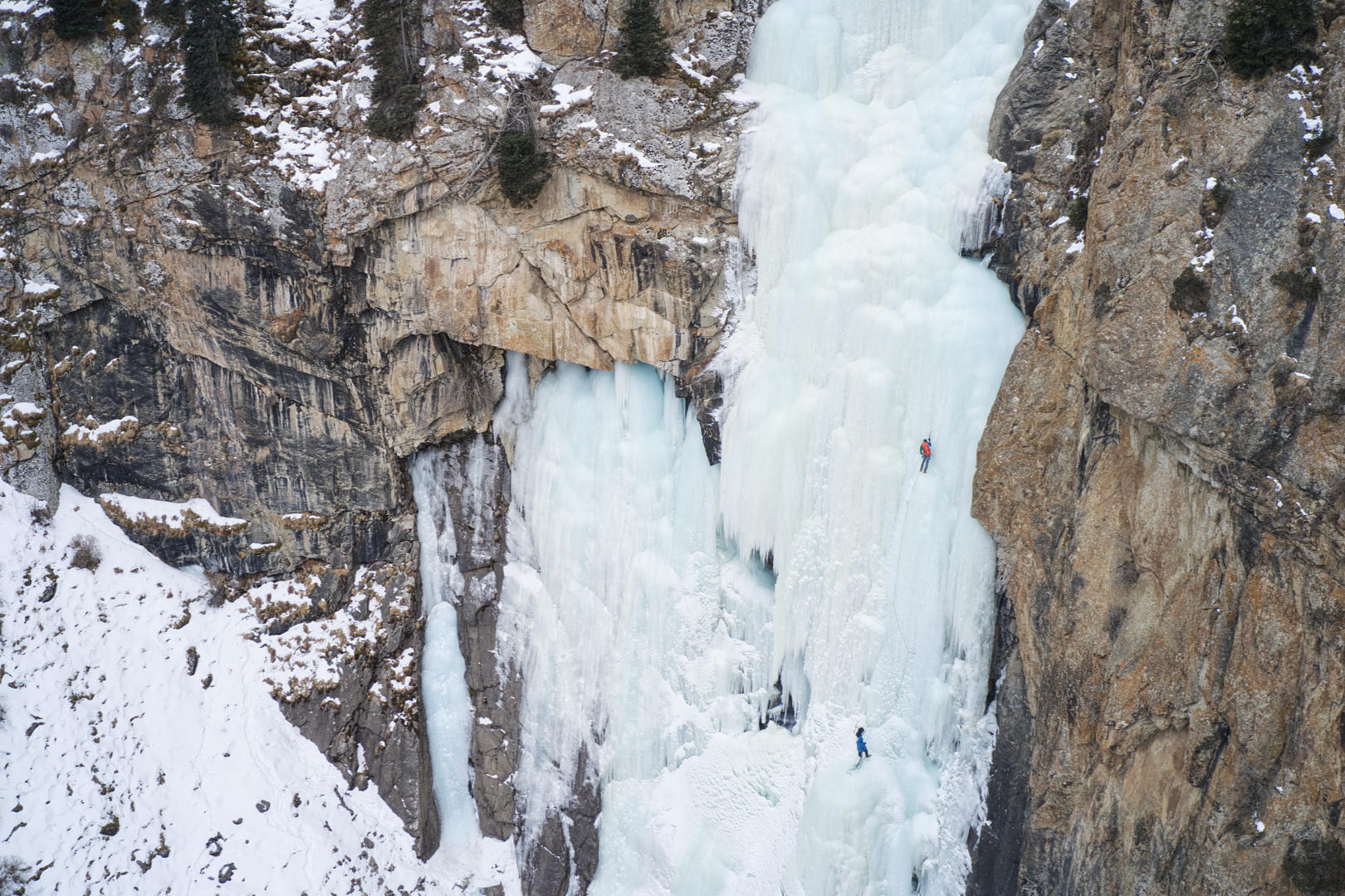 Kirill Belotserkovskiy and his guest Ivan climbing Barskoon waterfall, Alatau Guide