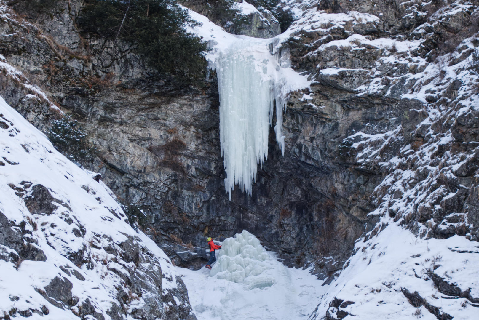 Kirill Belotserkovskiy below the hanging icicle, Alatau Guide